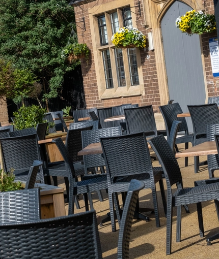 Exterior beer garden of a pub with a seating area.