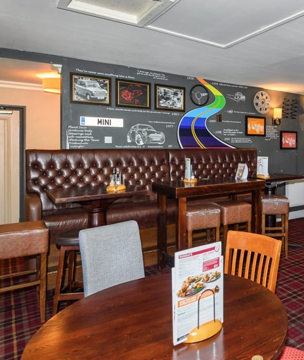 Interior dining area of a pub with a TV.