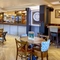 The bar and interior restaurant seating area at The Flying Horse in Heald Green, with gaming machines and a dartboard.