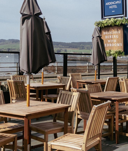 The beer garden near a waterfront outside the Ardencaple Hotel.