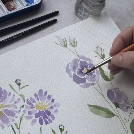 An image of a person painting flowers advertising a Watercolour Workshop What's On event at The Cart & Horses.