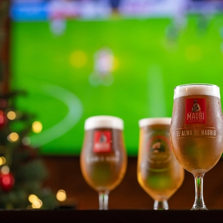 pints of beer in front of a TV