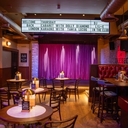 The interior restaurant and seating area with live event stage at The City Of Quebec.