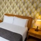 A interior double hotel bedroom with wardrobe, bedside tables and lamp at The Commodore.