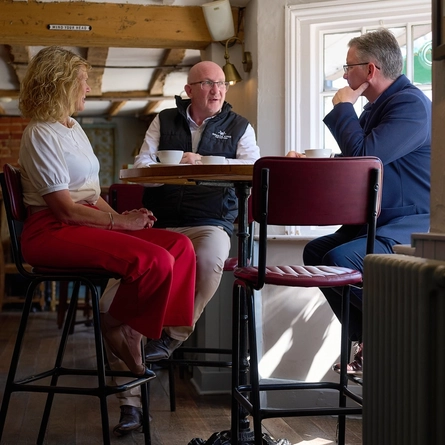 A Pub Partners image showing 3 people sat at a table within the Shinfield Arms.