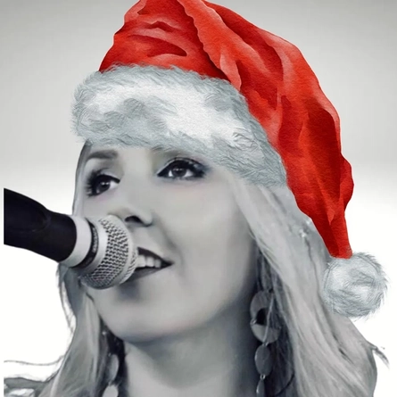 An image of Auriol wearing a Christmas hat to advertise a What's On event at The Crown.
