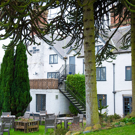 The exterior side view and beer garden seating area at The Blue Cap.