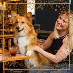 A woman sat in the pub with a dog