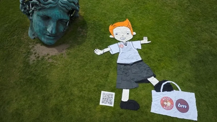 Exterior Overhead showing character made from school uniform next to statue head