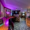 Interior dining area of a pub with a TV.