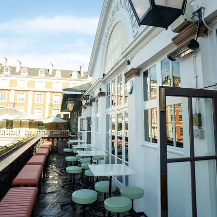 Exterior balcony seating area with bar stool, High tables and cushioned benches