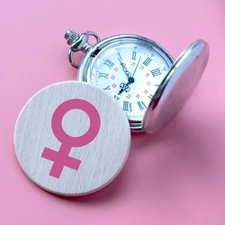 A stopwatch on a pink background.