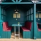 One of the under cover beer garden seating areas at the Golden Hind, made up of three booth seating areas with padded seats.