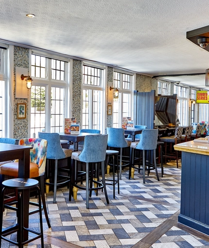 The bar and interior restaurant seating area with TVs and pub games, at The good Intent in Hornchurch.