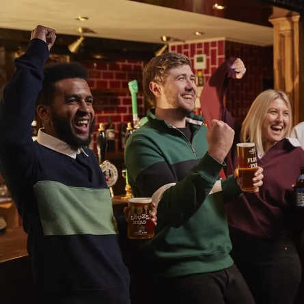 Guests cheering sports in the pub