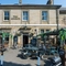 External view of a pub entrance and outdoor seating area