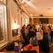 An image of customers stood within the interior restaurant seating area with the bar in the background enjoying drinks at The Kings Stores.