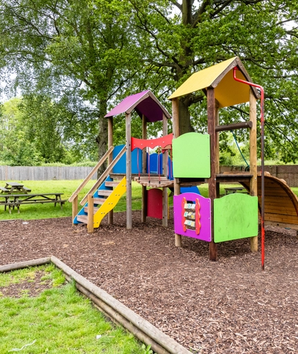 Exterior play area and seating area of a pub.