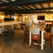 Interior dining area of a pub with a few TVs and a fireplace.