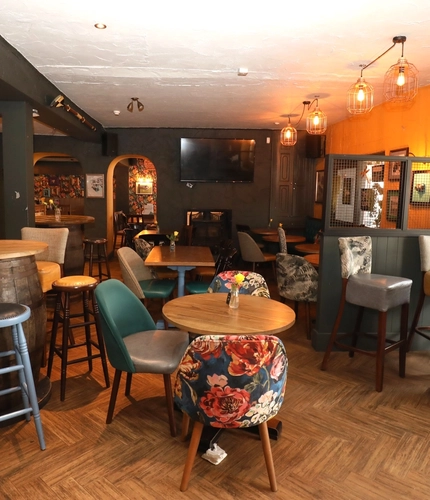 interior dining area of a pub with a TV