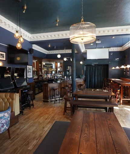 The interior seating area with TV and pub games, at Shakespeares in Edinburgh.
