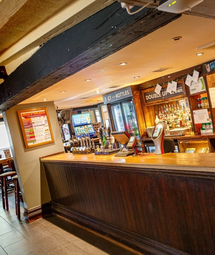 Interior bar area and dining area of a pub.