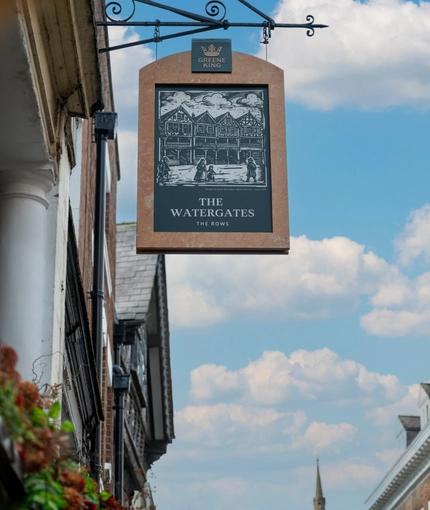 A close up image showing the exterior venue hanging signage featuring an old illustration of the venue at The Watergates Bar.
