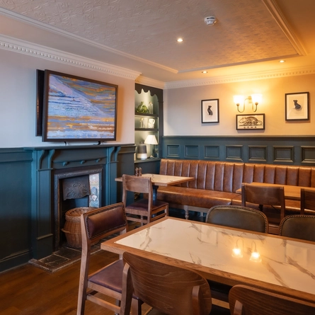 The interior seating restaurant area with ornate fireplace inside The Magpie.