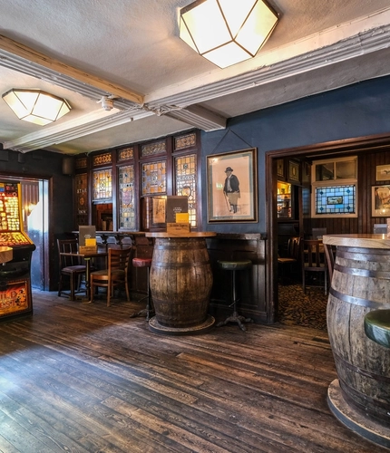 The interior restaurant seating area with pub games at Ye Olde Starre Inne.