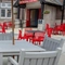 The exterior beer garden seating area at The Railway in Meols, with wooden tables and chairs, and shade umbrellas.