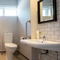 The interior accessible hotel bathroom with toilet, sink and shower with shower chair at the Cedars Inn.