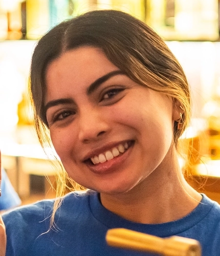 An image of a member of staff stood behind the interior bar pulling a pint of lager at The Kings Stores.