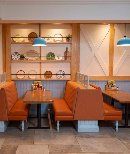 The interior restaurant seating area booths with cushioned seating at The Farmhouse Kitchen Willington.