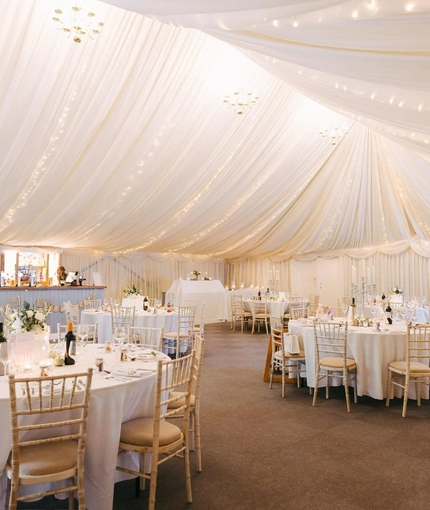 A marquee, decorated for a wedding.