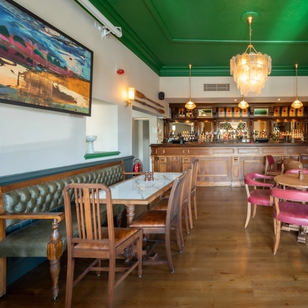 The bar and interior seating restaurant area with ornate fireplace inside The Magpie.