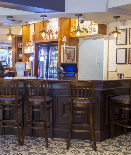 Interior bar of a pub with a seating area.