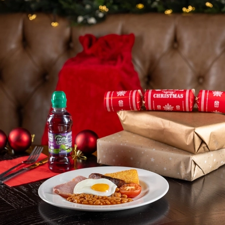 A kids breakfast on a table, next to some presents.