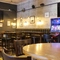 Interior dining area of a pub with a TV and a gambling machine.