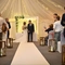 A bride and groom standing at the altar, holding hands.