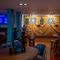 The interior games area at the Counting House, with TVs on the walls, two illuminated dartboards, a pool table, and restaurant seating nearby.