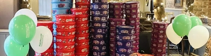 Stacks of Christmas sweet tubs in a pub.