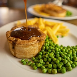 british pie served with peas and chips