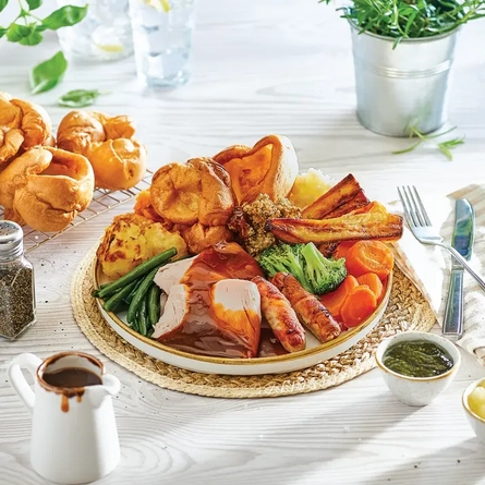 Well presented food plated and placed on a table with a plant