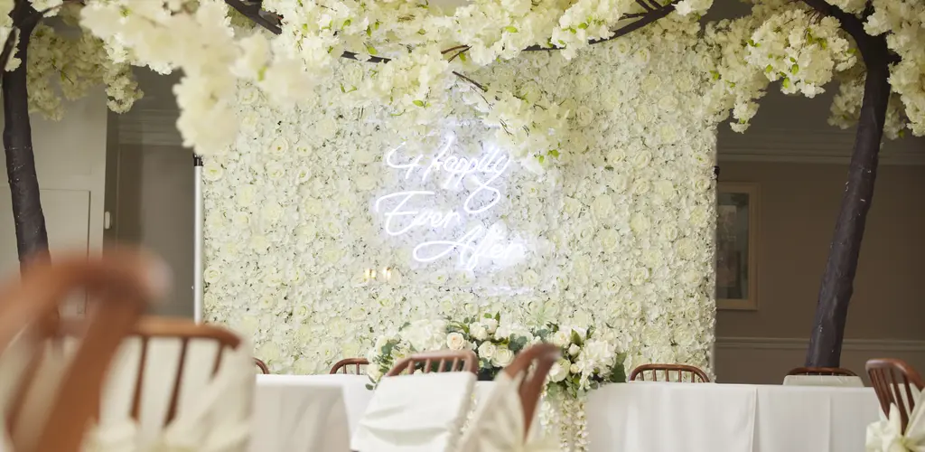 A floral wall with the phrase "Happily Ever After"