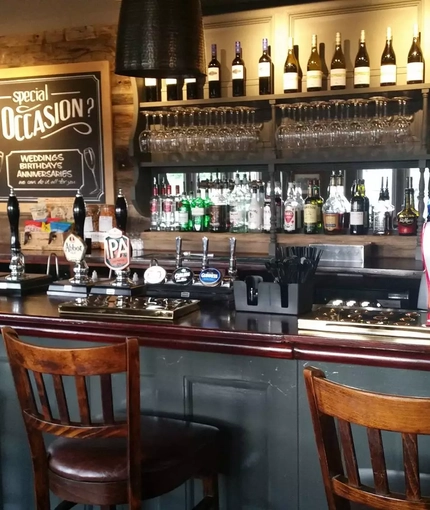interior bar area of a pub with a seating area