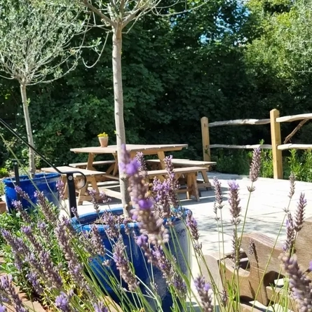 An image of an exterior beer garden seating area advertising a What's On event at The Crown.