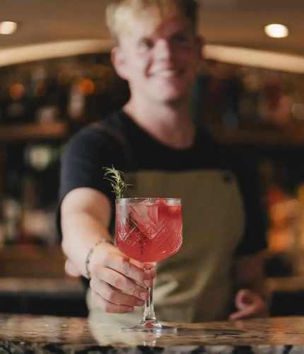 Bartender serving a Strawberry Spritz