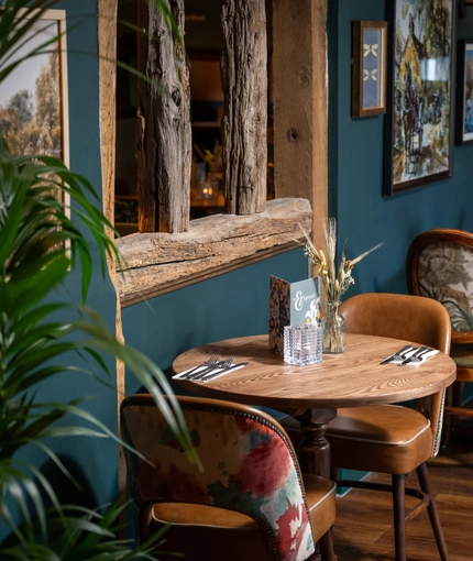 A table in the restaurant of the Three Horse Shoes.