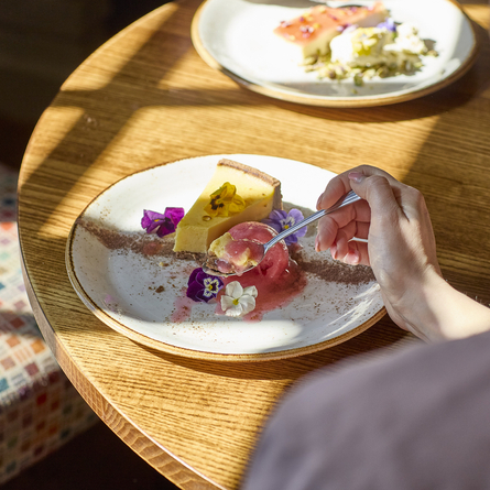 An image showing the rose petal and pistachio panna cotta and clementine tart at Chef & Brewer.