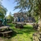 Exterior beer garden of a pub with a play area and a seating area.